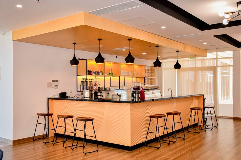 The coffee bar with stools and pendant lights