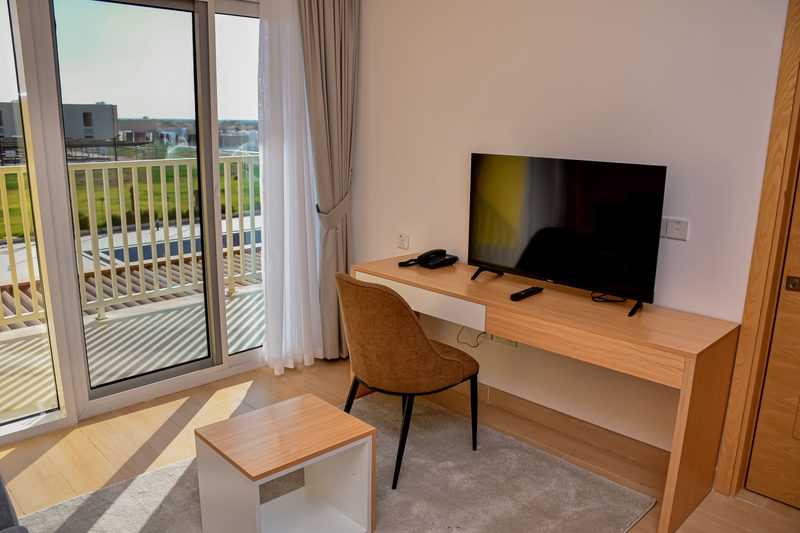 En-Suite Room work desk and TV beside the balcony doors