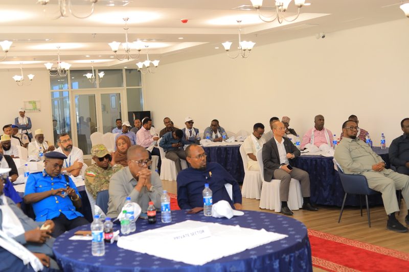Guests listening at round tables in the Ballroom