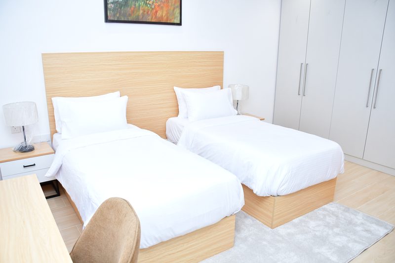 Villa bedroom with a fitted wardrobe and bedside lamps